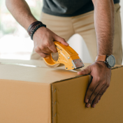 Person taping Shipping Box