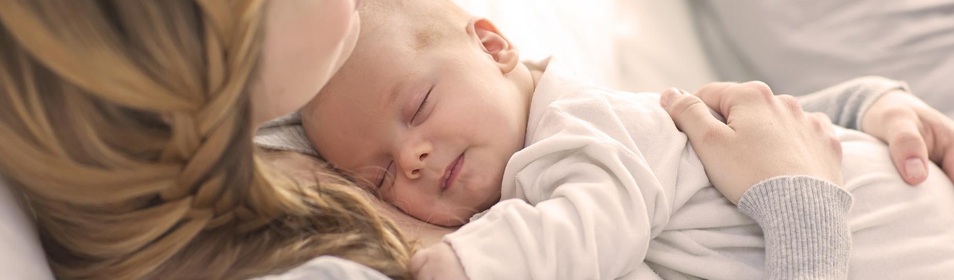 Baby lying on mum