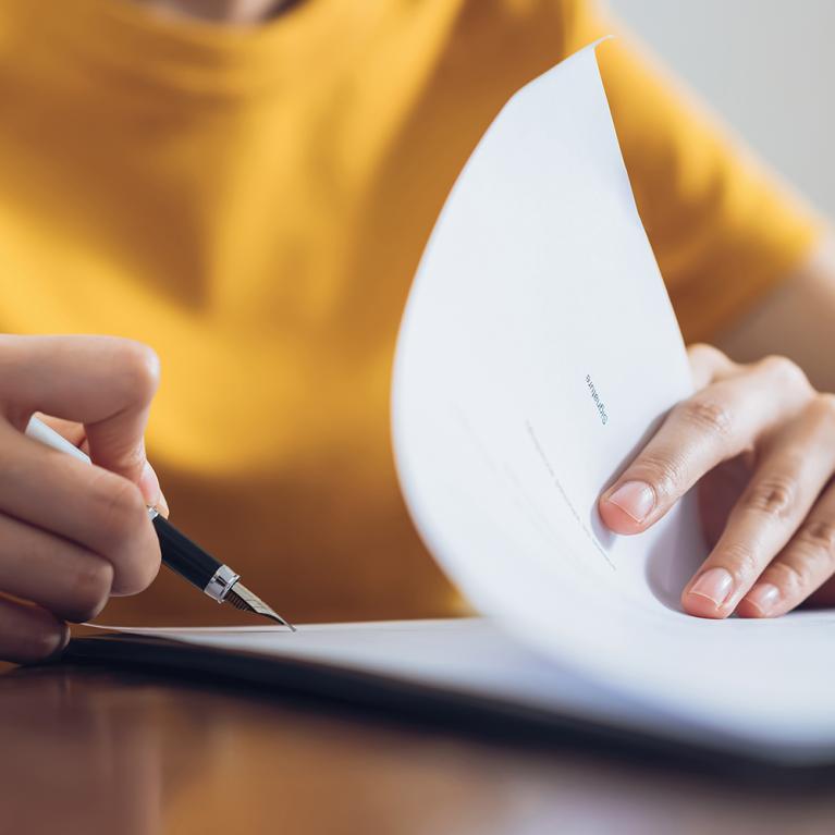 An Individual Filling Out Shipping Insurance Forms