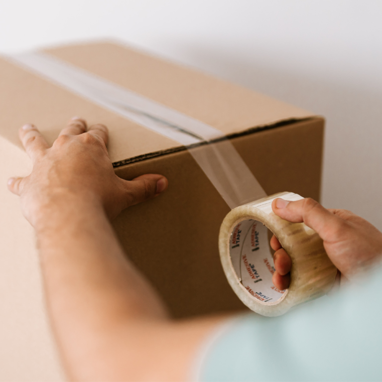 Carton being sealed by packaging tape