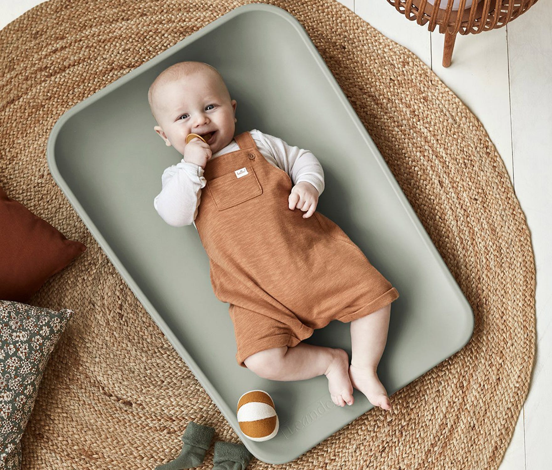 Baby lying on mat on floor