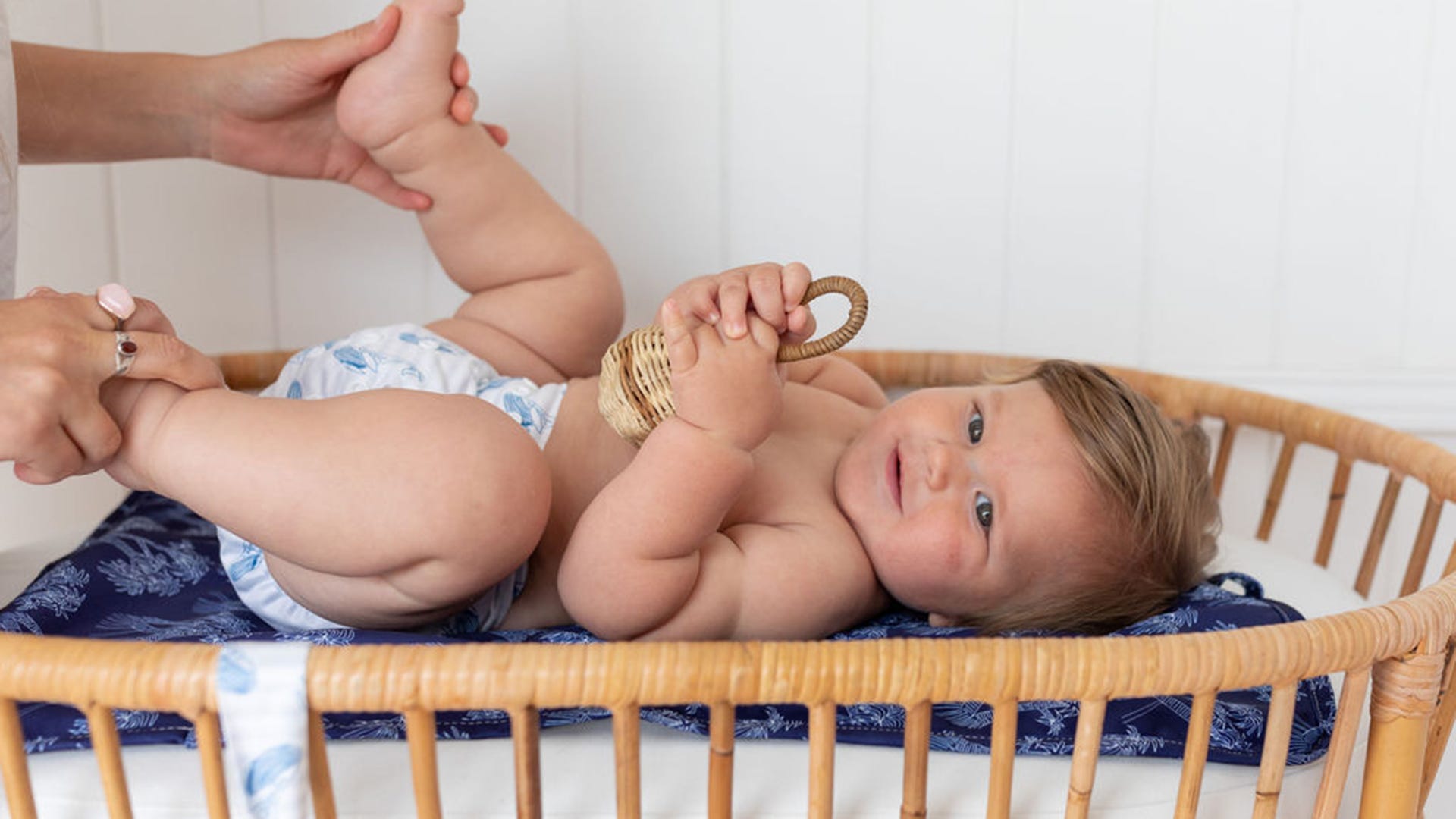 Baby on changing table with reusable nappies