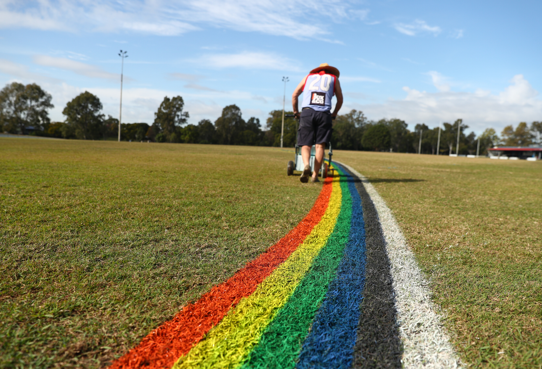 Football field being marked with rainbow