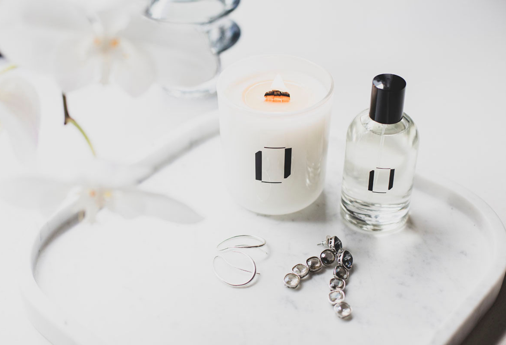 Lumen + Luxe candle and room spray on marble countertop