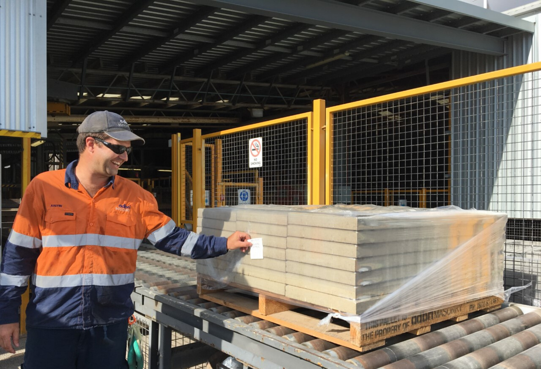 Man applying label to pallet