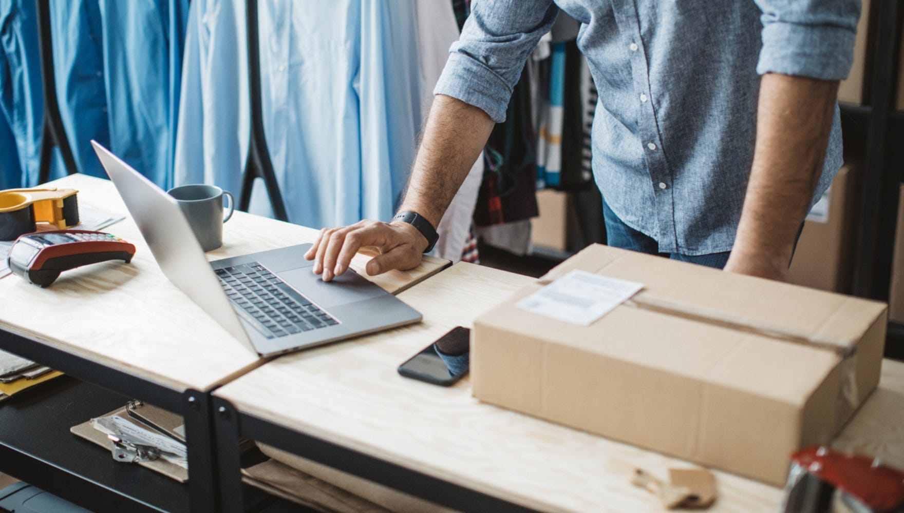 Man working on laptop on packing bench