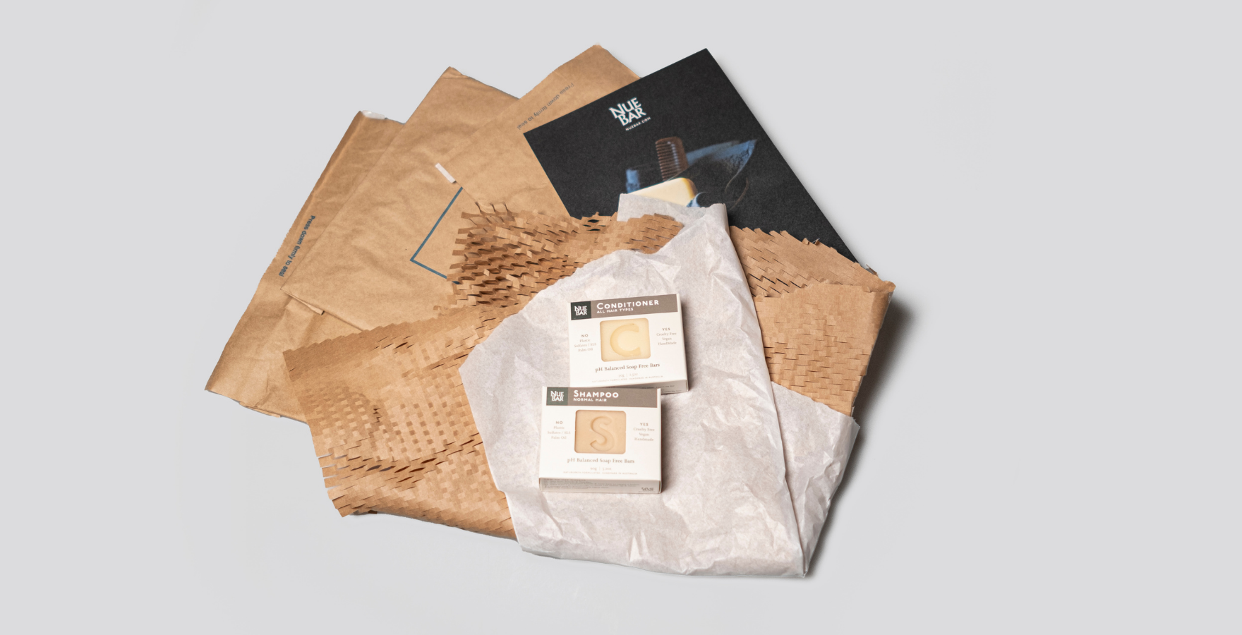 NueBar product on top of Geami Kraft and Jiffy Bags