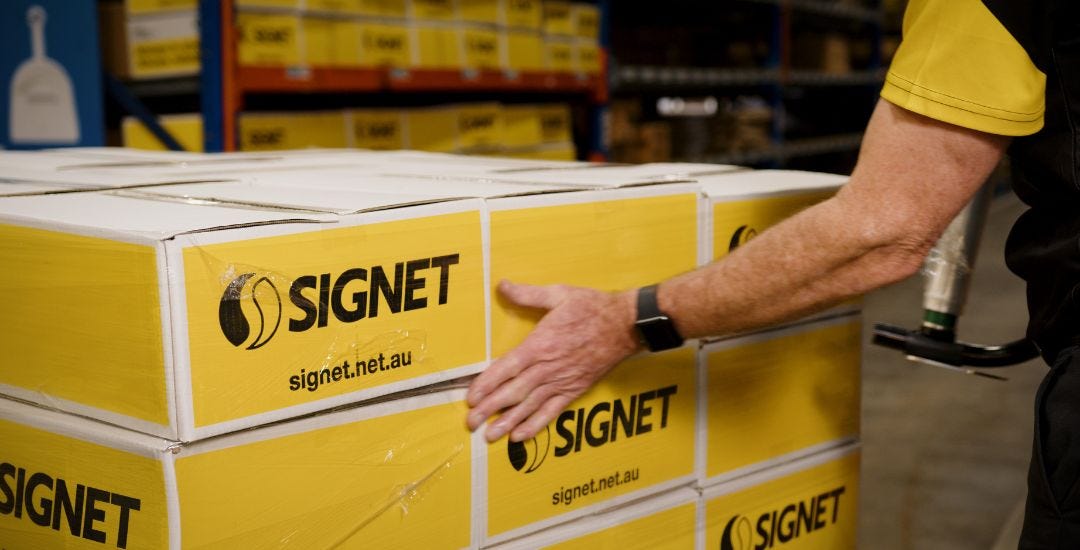 Person Smoothing Down Film On Pallet