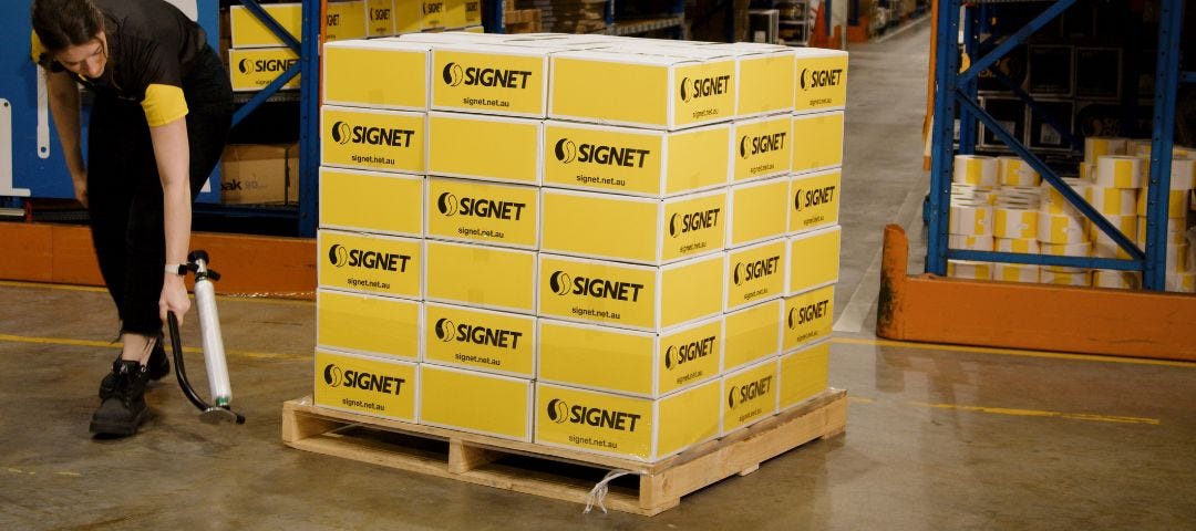 Person Wrapping Pallet In Warehouse