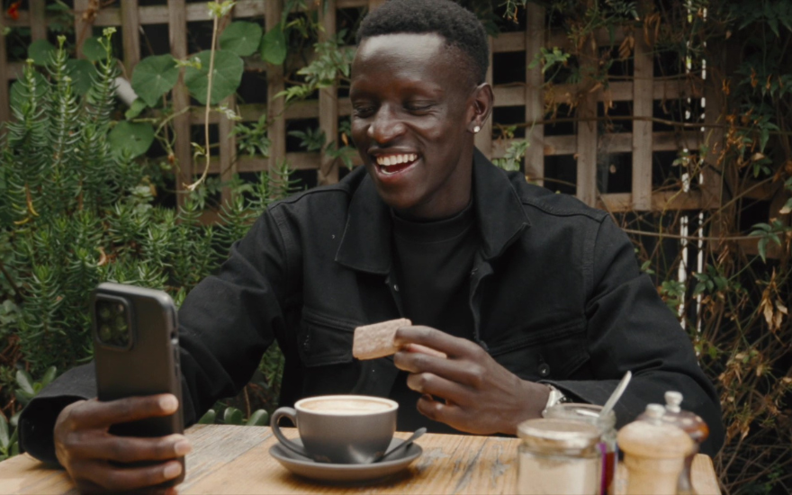 Peter Bol eating TimTam at Cafe