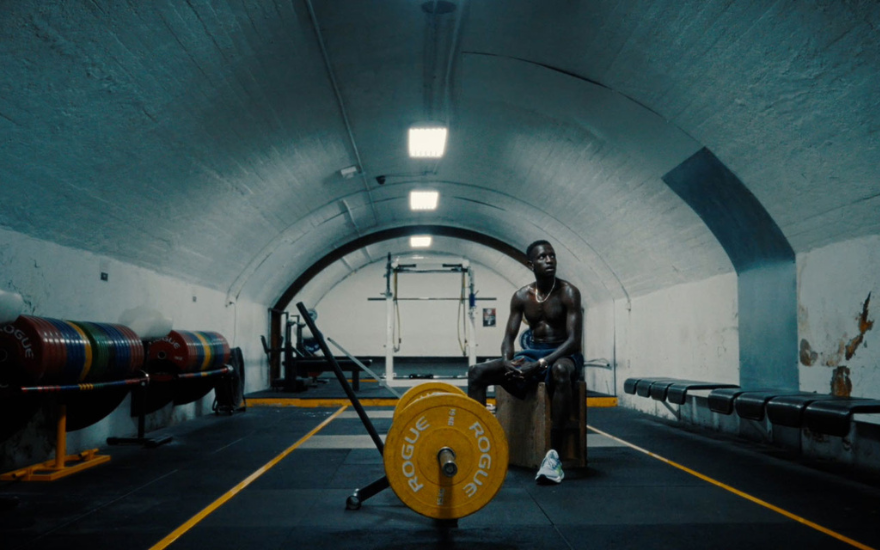 Peter Bol sitting in a gym after workout