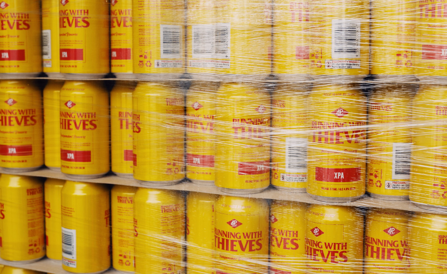 Running with Thieves drink cans wrapped on pallet