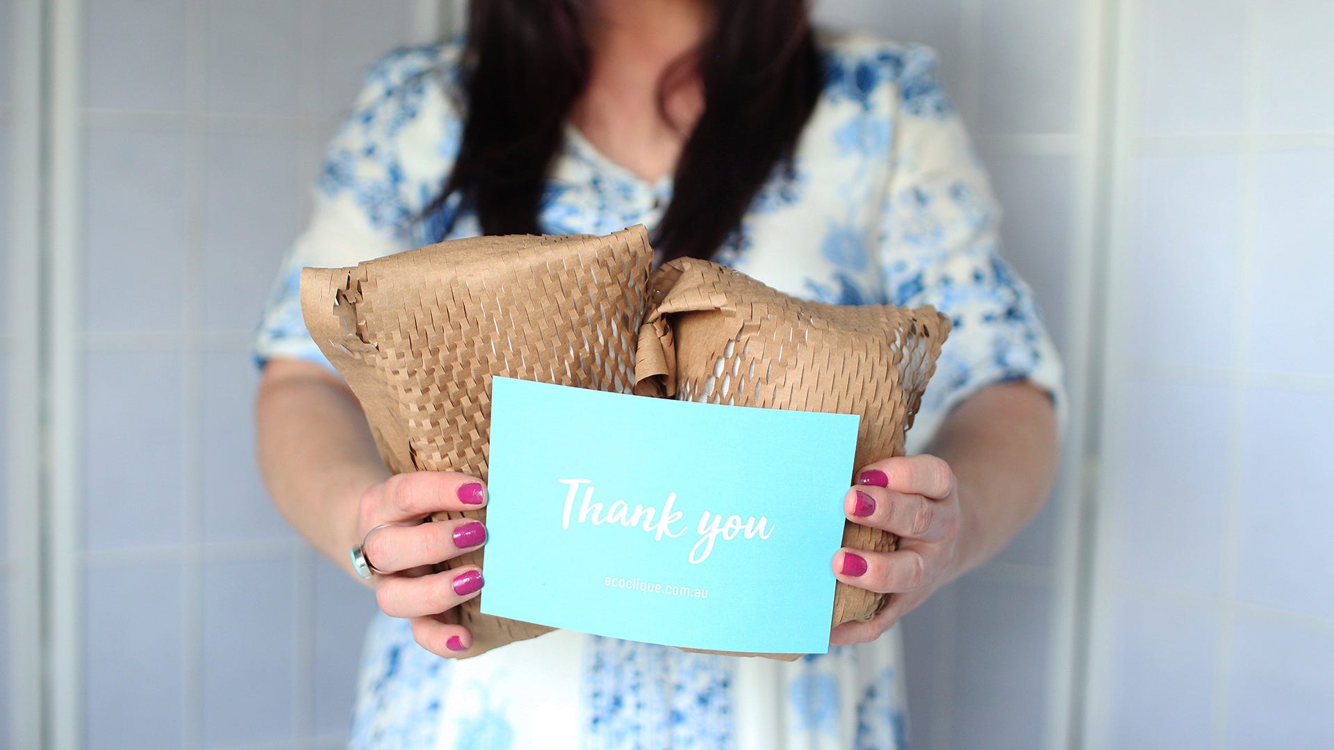 Simone holding packages with thank you note