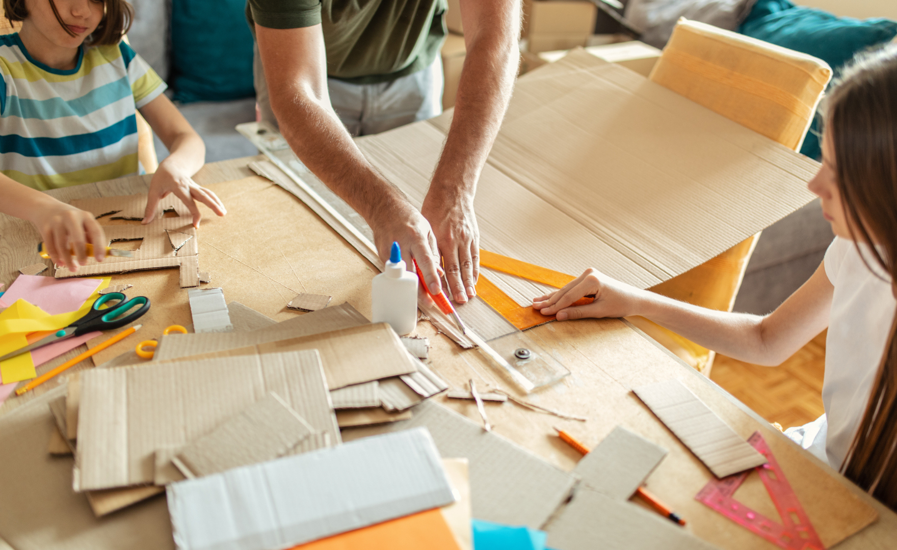 parent and children making crafts with cardboard