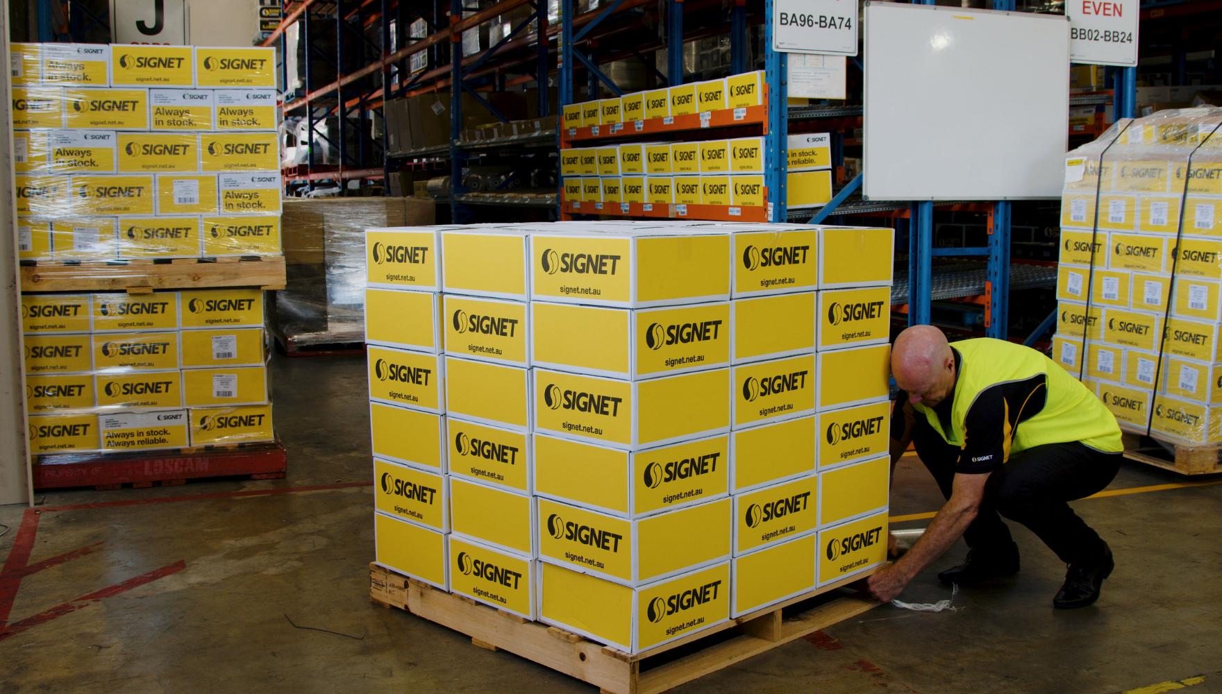 Person Securing Film Tail underneath Pallet